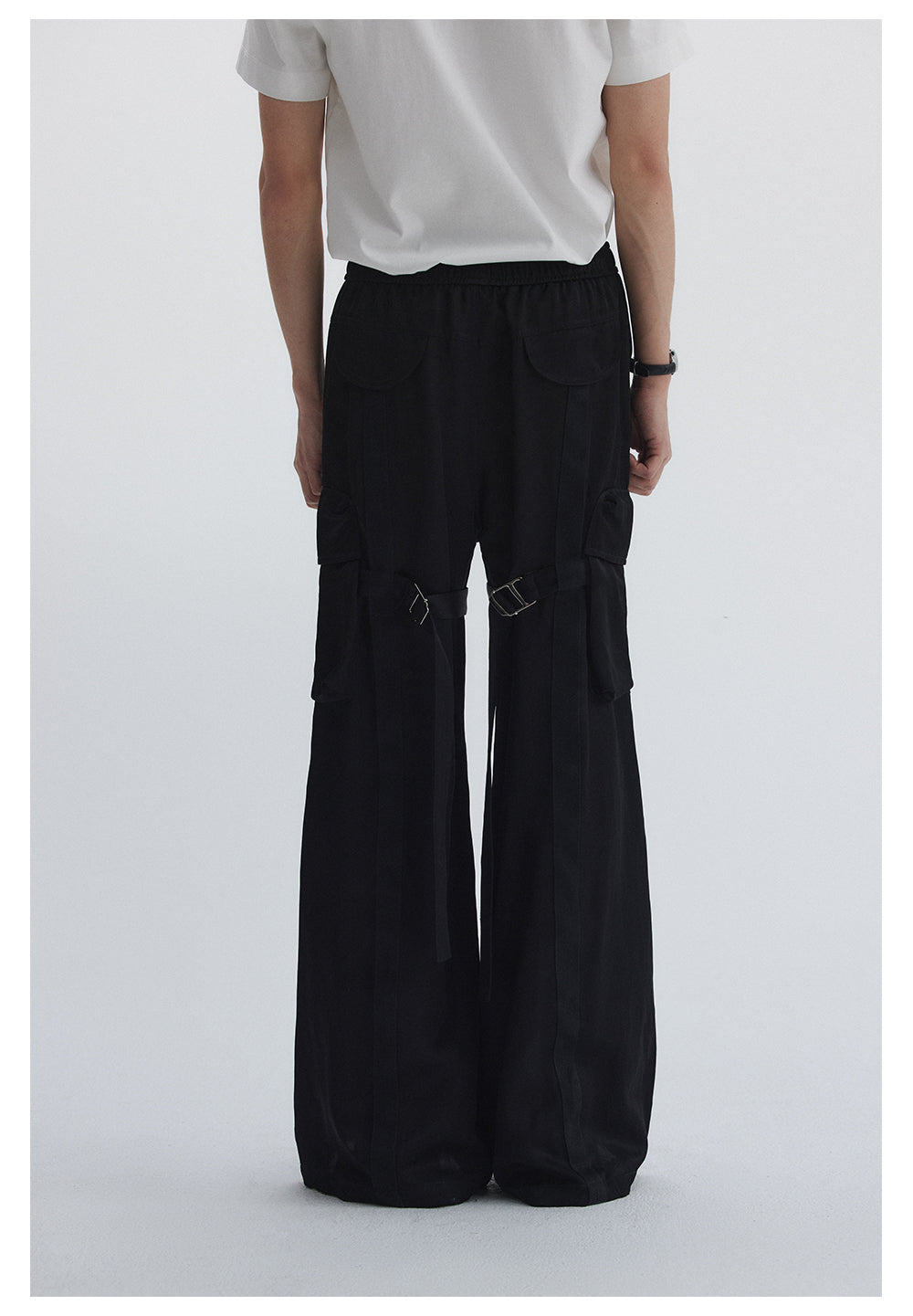 Straight pants with irregular design straps